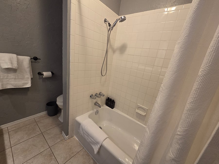 Bathroom with double sinks and bath/shower.