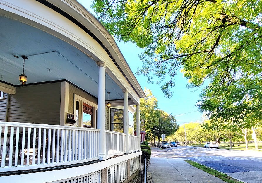 Front porch overlooks the park on an exclusive street in this neighborhood with large Victorian style homes.