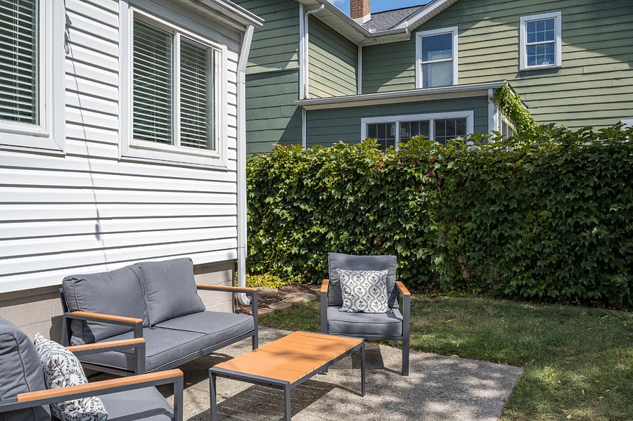 Patio with comfortable furniture in the fully fenced in backyard