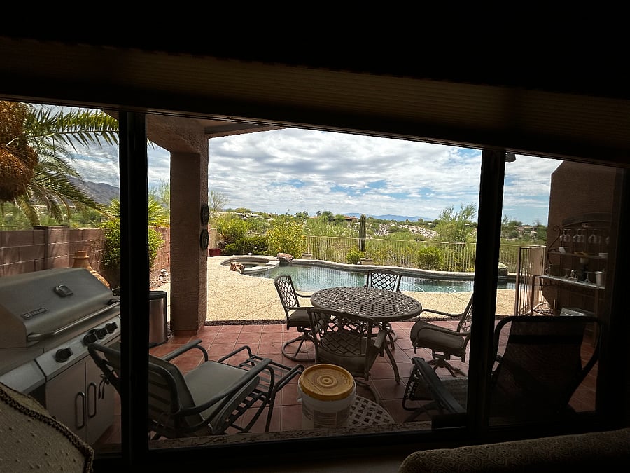 Back patio with pool, hot tub, mountain views, and grill