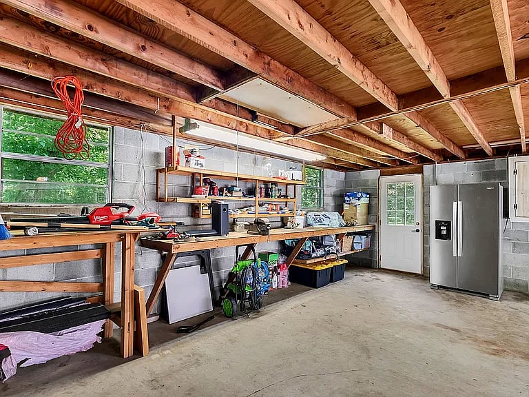2nd fridge and freezer in detached garage + workbench and storage