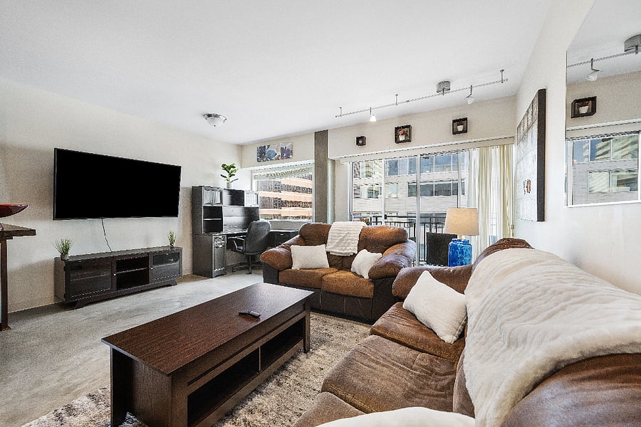 Full size couch and loveseat with a 65" Smart TV and large desk.