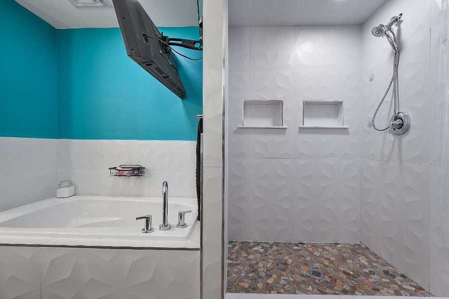 Large walk in shower and jetted bathtub with Smart TV.