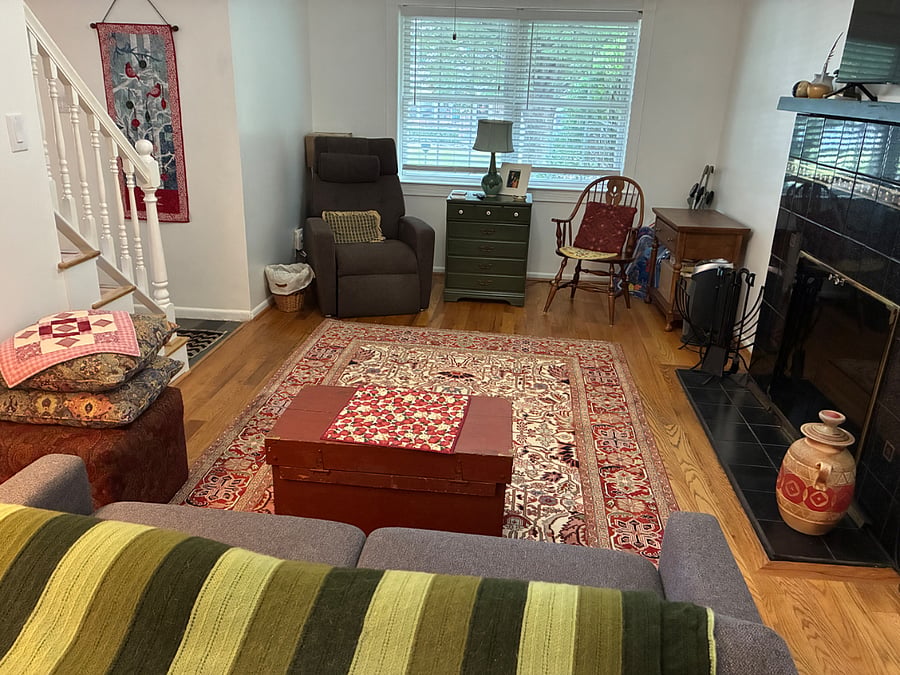 Family room with wood burning fireplace and large TV
