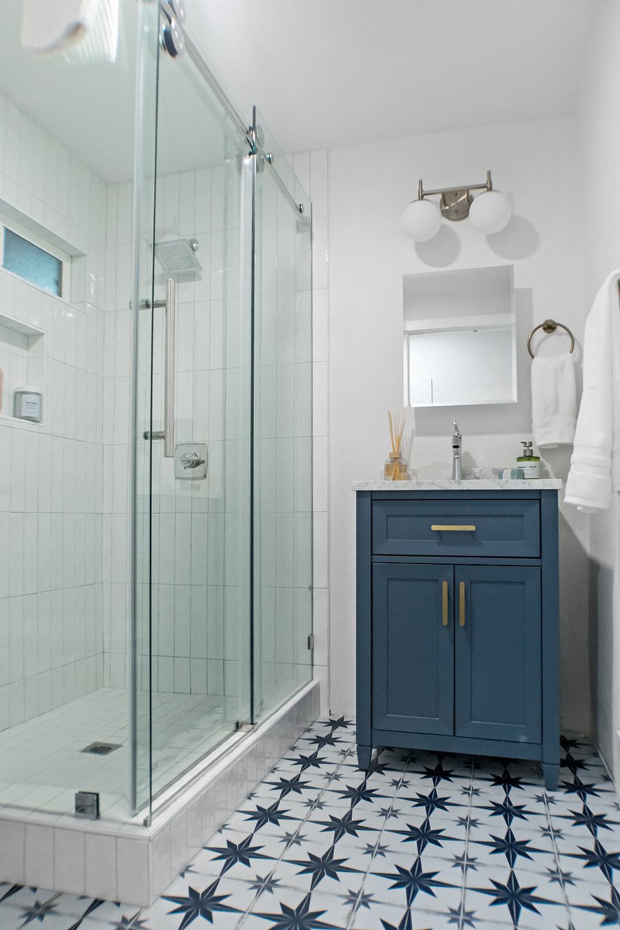 Enjoy this brand new bathroom! It features beautiful tile finishes, a custom glass shower, and is fully stocked with body wash, shampoo, conditioner, and hand soap