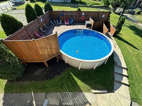 4 ft above ground pool in side yard w/ privacy deck open May - Sept
