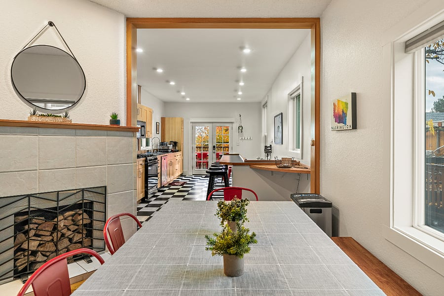 Open concept living with dining table between kitchen and living room