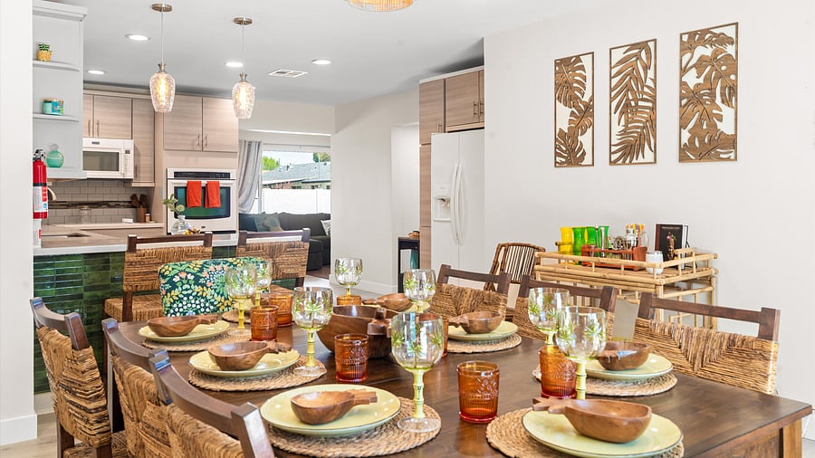 Gather for dinner at the tropical-inspired dining table with textured chargers and tiki-colored glassware.