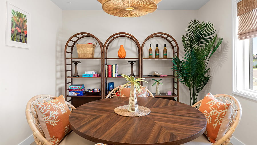 Game-ready corner stocked with classics, tropical touches, and palm-silhouetted wall art for laid-back fun