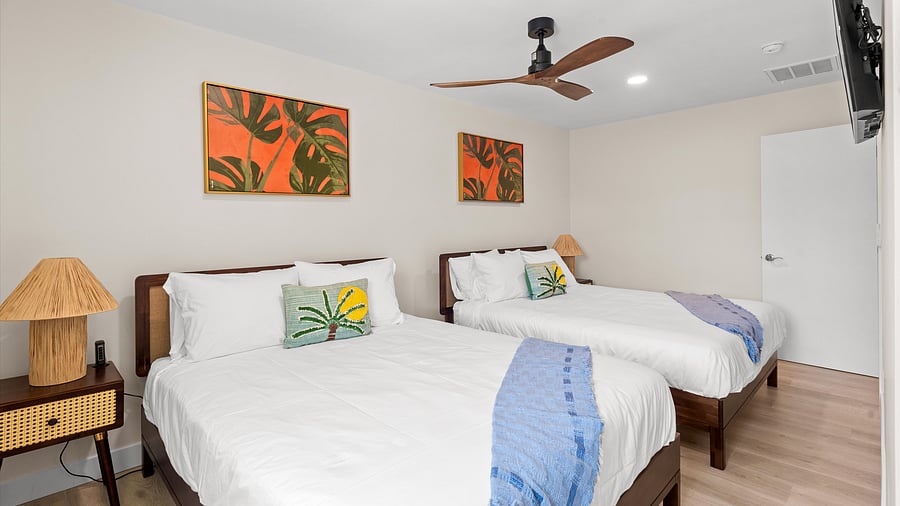 Bold Island art in guest bedroom with two queen beds
