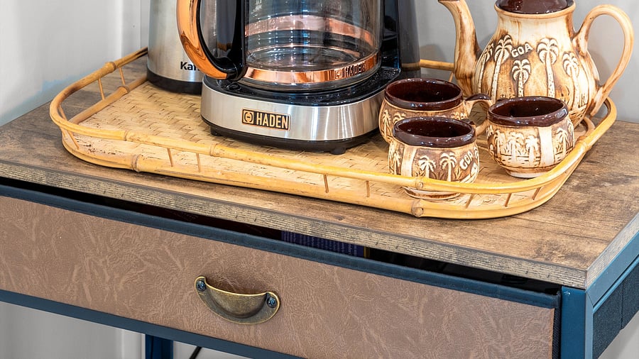Retro tea setup with palm tree ceramic mugs and a Haden Coffee pot