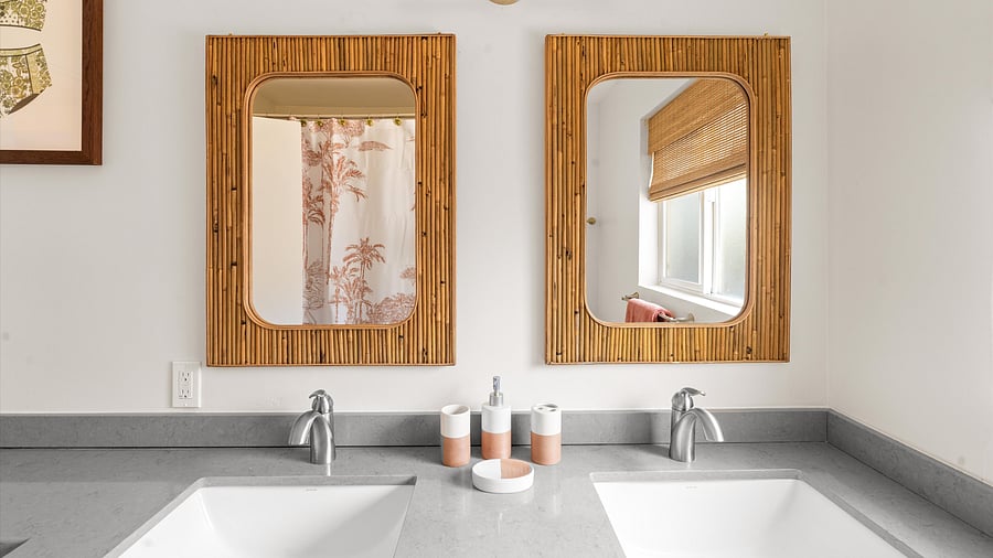 Dual sink vanity with palm tree-themed decor and coral accents for a coastal feel