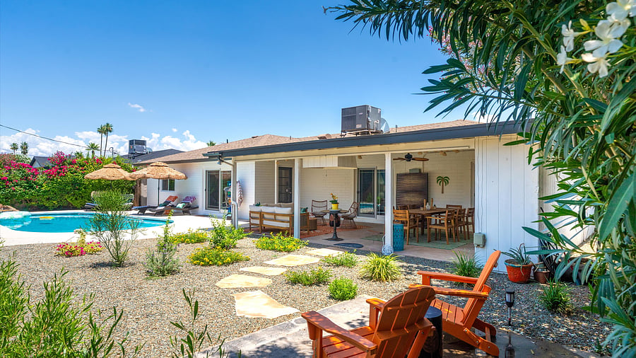 Private garden retreat with fire pit seating and lush tropical landscaping - perfect for morning coffee or starlit chats.