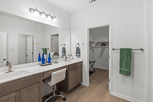 Primary Bedroom on suite with Big Shower and Vanity Chair and Mirror.