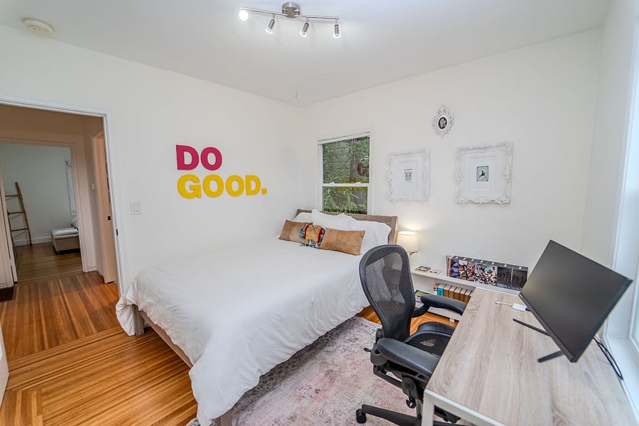 Bedroom 2 with queen bed, office desk, monitor, and closet