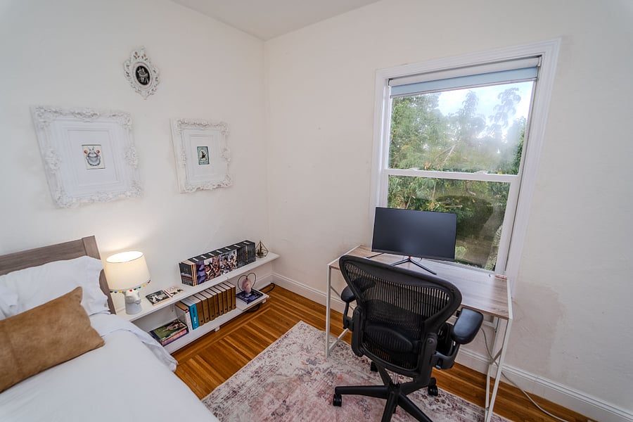 Bedroom 2 with queen bed, office desk, monitor, and closet