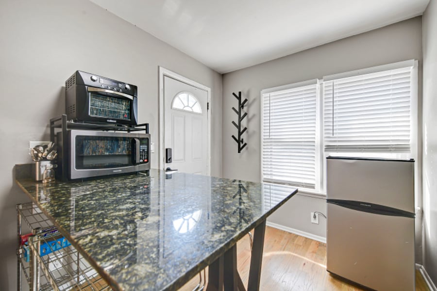 Interior side of entrance with coat hook, open to kitchenette.