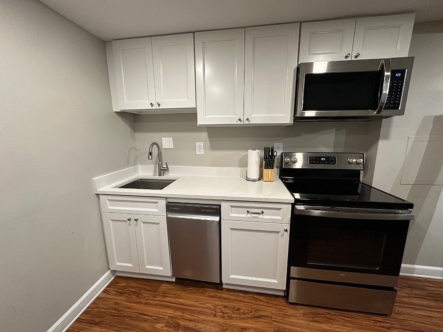Full size range. Brand new cabinets, countertop, microwave & dishwasher.