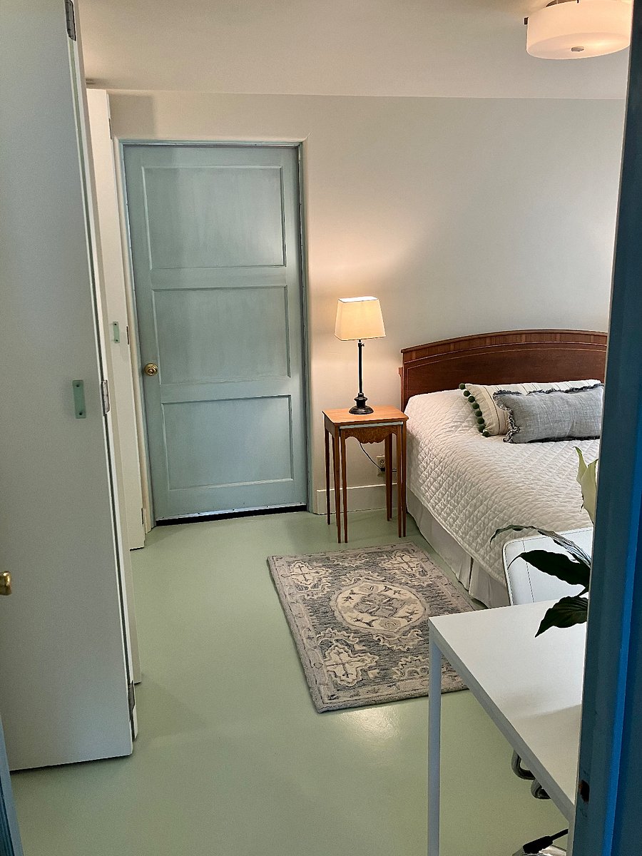 Medium-sized bedroom features organic Naturepedic mattress and frame, luxurious Ralph Lauren thick wool area rug.