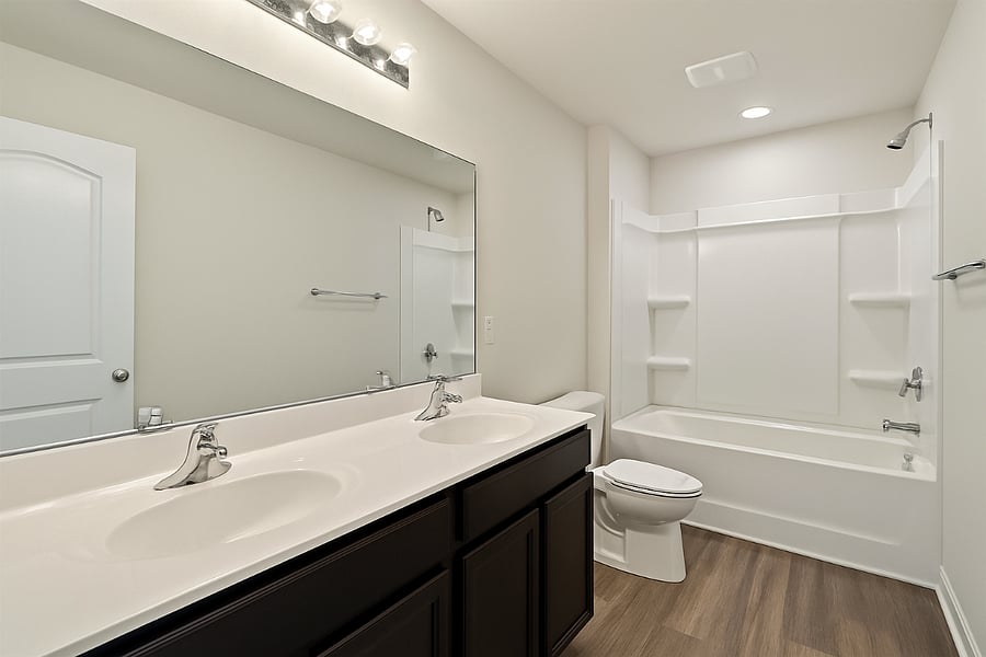 Shared bathroom with dual sink. This shared bathroom is professionally cleaned once per month.
