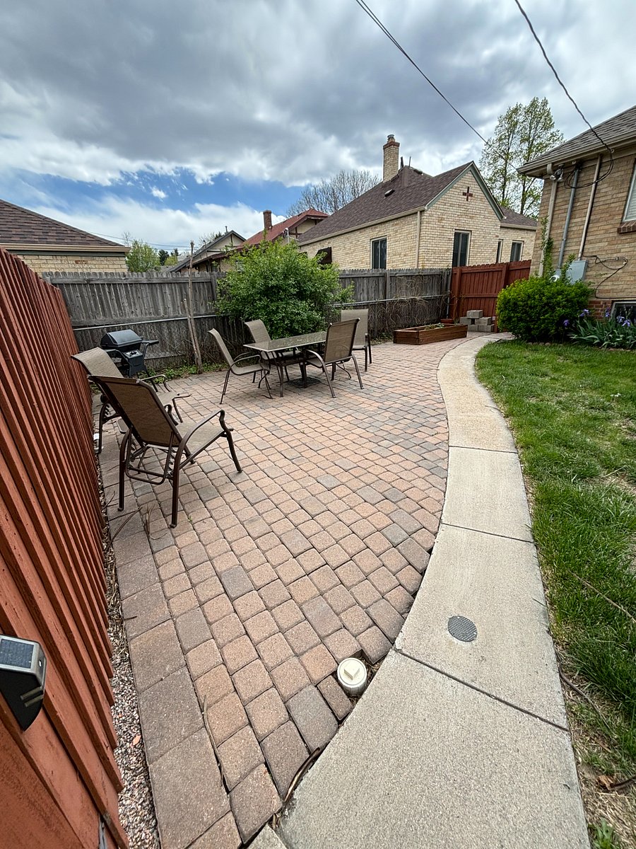 (Shared) fully fenced yard with outdoor dining, gas grill, and garden area.
