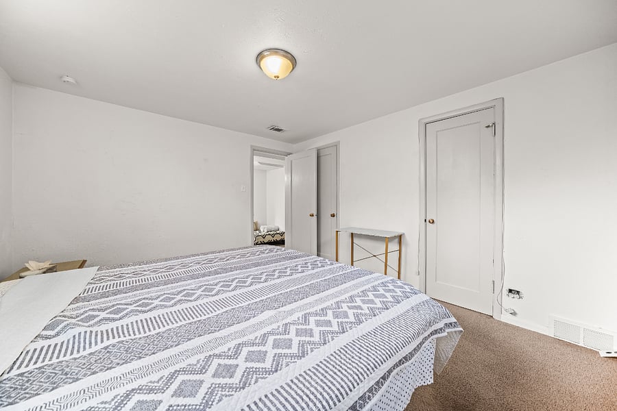 Primary bedroom with king bed and closet storage.