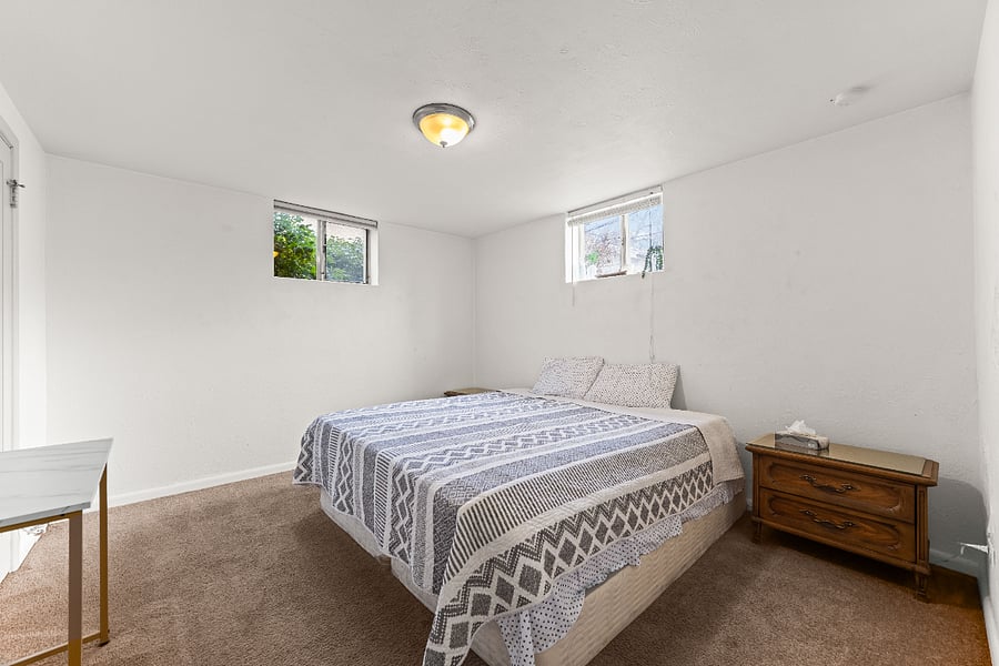 Primary bedroom with king bed and mattress topper.