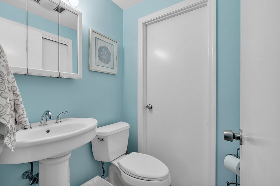 half bath off the hallway leading to the bedrooms