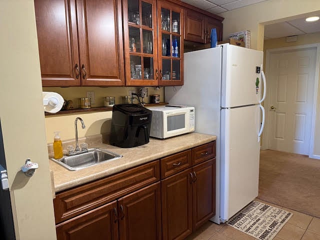 Kitchnette area with refrigerator, microwave, air fryer, and wet bar space. There is also a larger kitchen in the home which can be used for cooking meals, if desired.