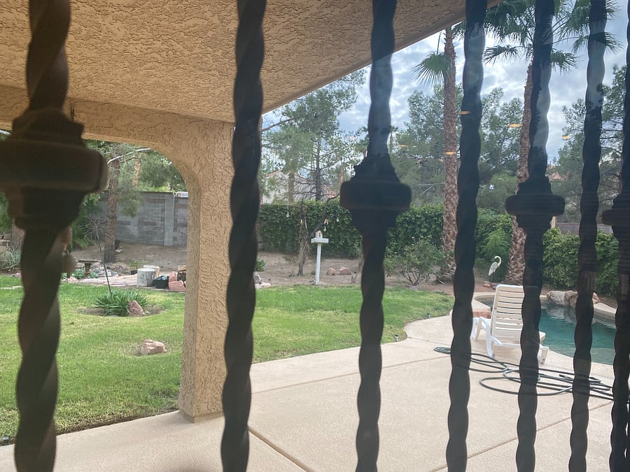 Looking out the iron protection doors keeping little ones from going in pool unattended.
