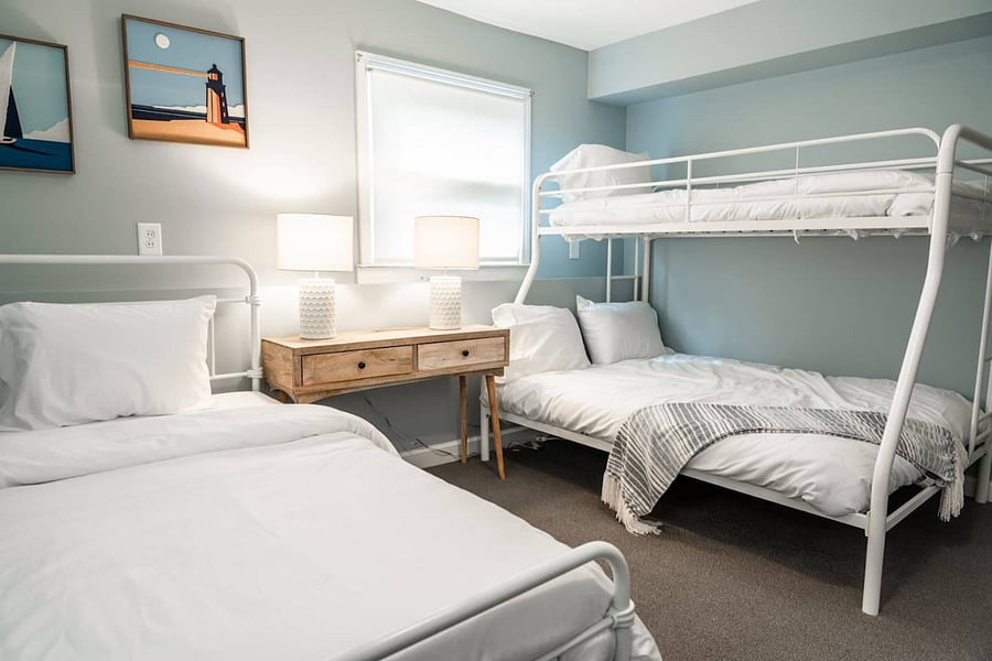 Lower level bedroom with twin over queen bunk beds and separate twin bed