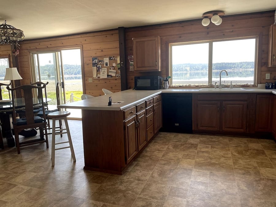 Kitchen, dining area, living room, large wrap-around deck access.