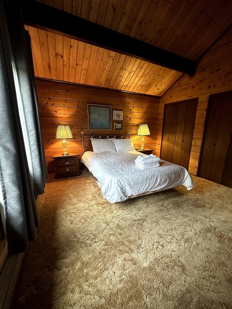 Upstairs bedroom #2. Queen bed with attached/shared bathroom. Facing back of home.