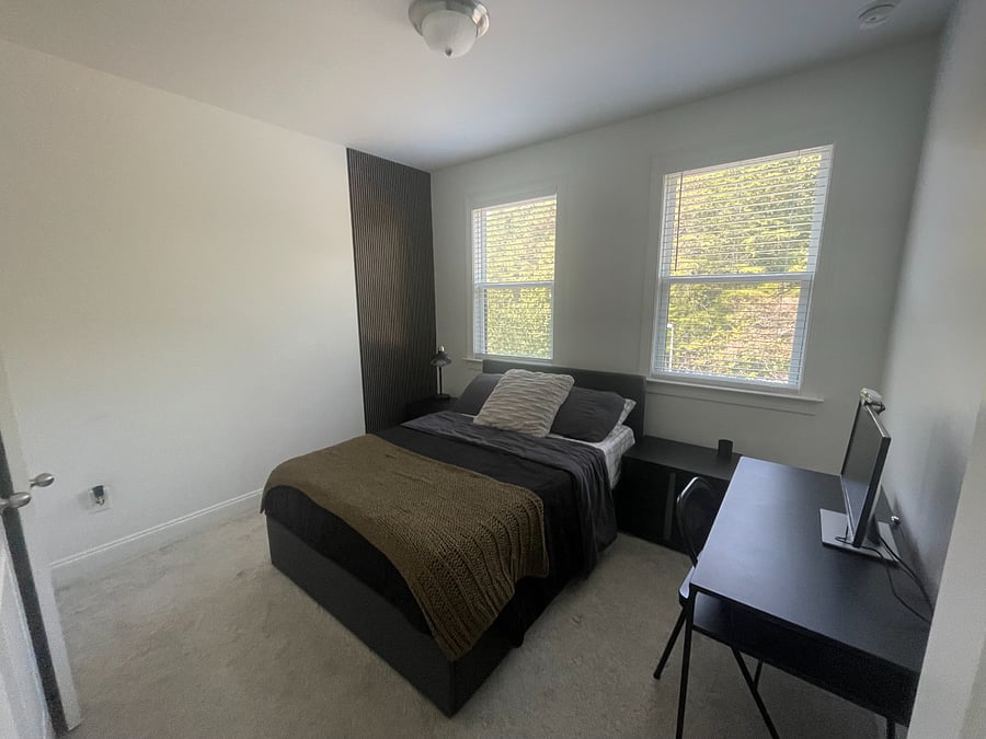 Private upstairs bedroom with full bed, desk, and second monitorideal for work or study. Bright windows bring in plenty of natural light.