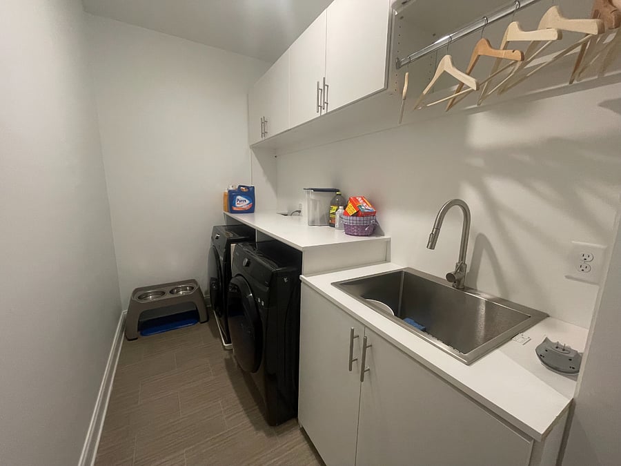 Dedicated laundry room with full-size units and plenty of storageeverything you need at home.