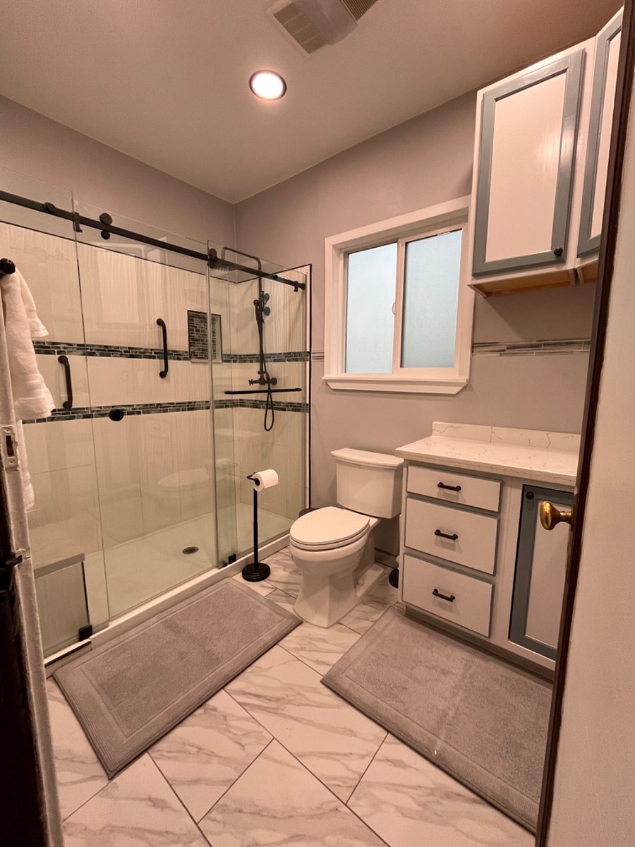 Bath with walk in rain shower with bench seat