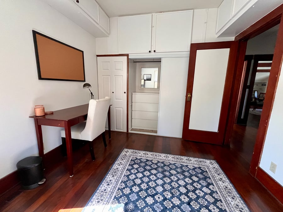 Office/2nd Bedroom with view of secluded dresser and mirror in linear closet