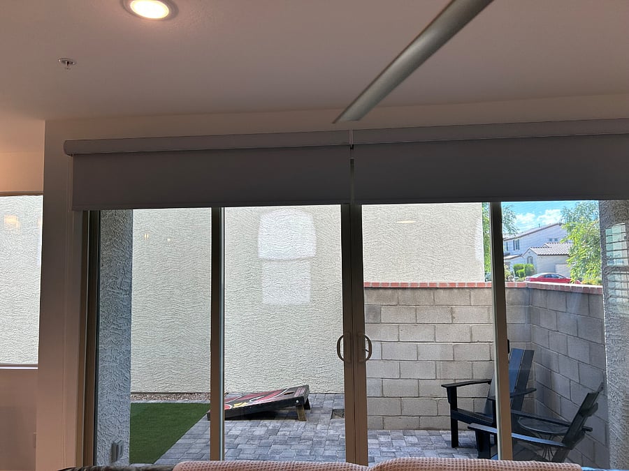Private indoor outdoor living with cornhole and turf ready for your outdoor fun. 12 foot sliding glass door with blackout roller shades