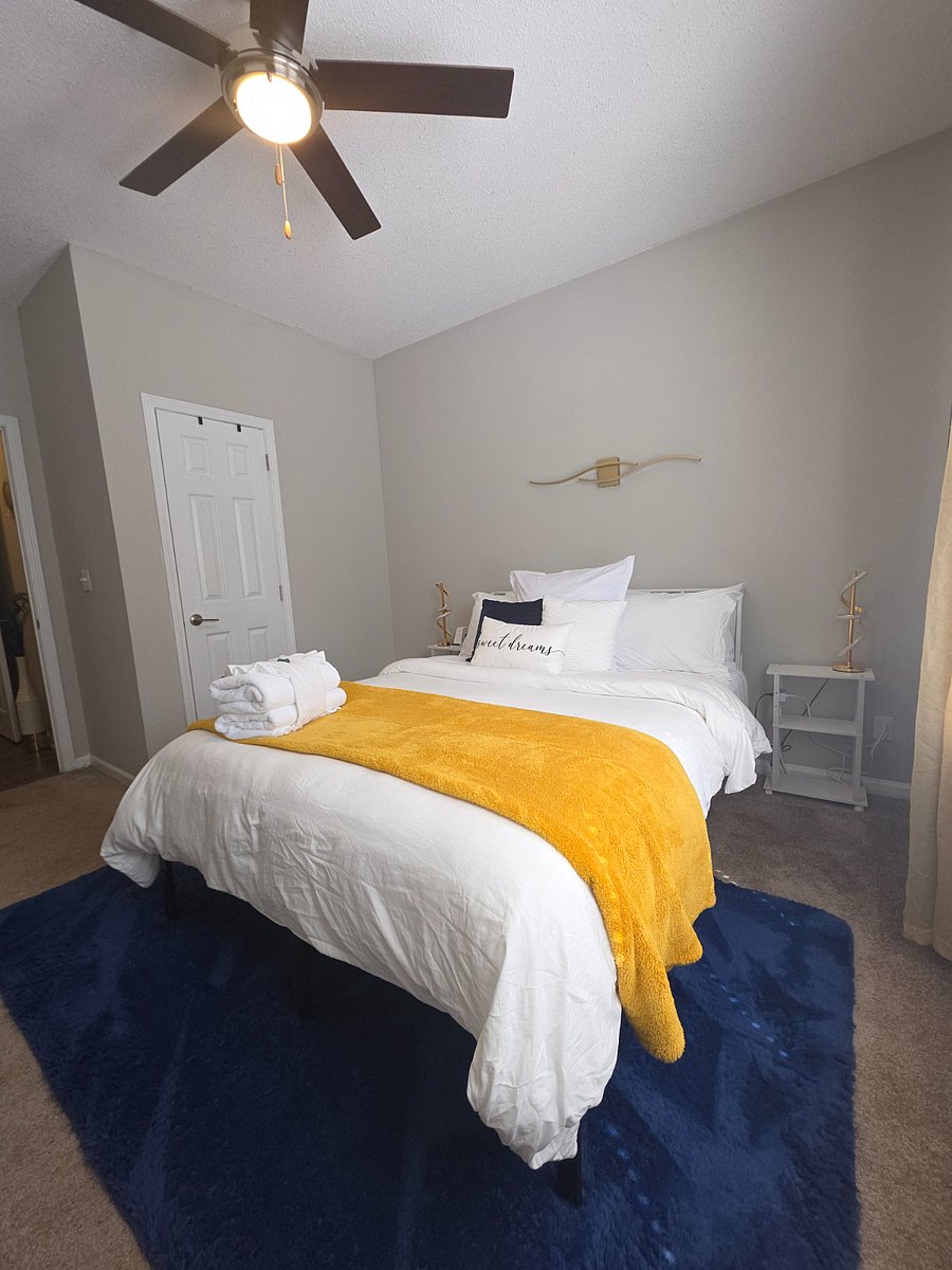 Recharge in the first bedroom with a queen-size bed, private ensuite, walk-in closet, and blackout curtains for restful nights.