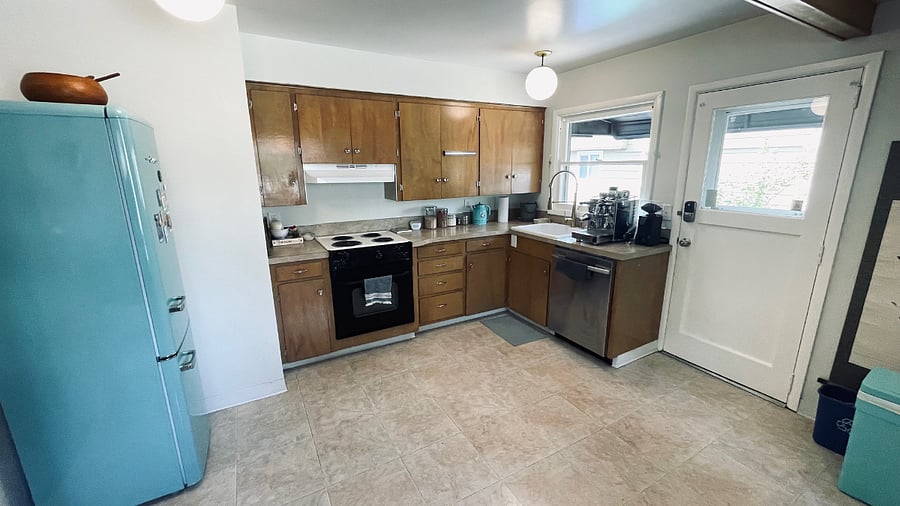 Kitchen with oven and cooktop, toaster, kettle, Instapot, espresso machine, and French Press coffee maker