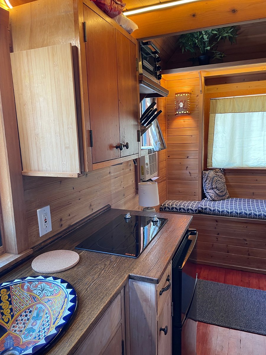 More detailed view of kitchen. Induction cooktop with two burners. Toaster oven. Mini fridge with separate freezer. All brand new as of June 2026.
