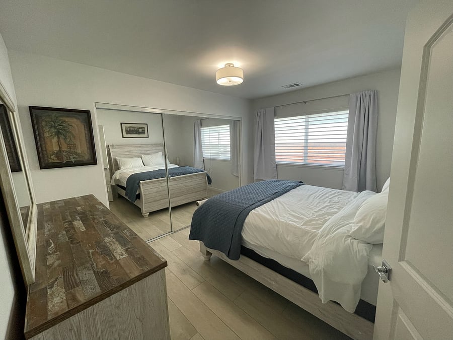 2nd Bedroom, Queen-sized bed, room darkening curtains, large closet, dresser and nightstand, shares bath with 3rd bedroom