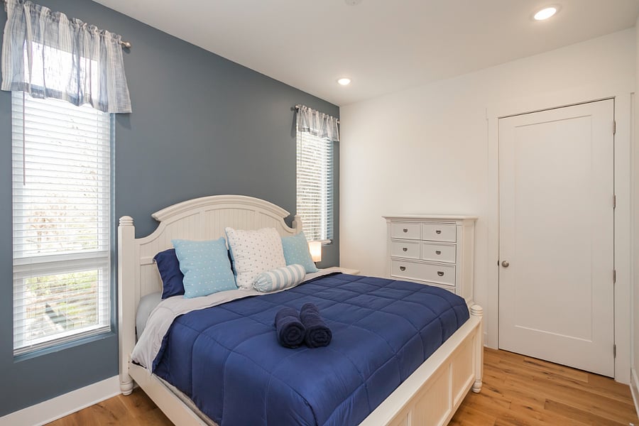 Bedroom 1 has lots of light with darkening shades, a large closet and dresser for plenty of storage space.