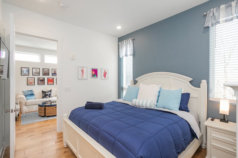 Bedroom 1 off living space includes a king bed and plenty of wardrobe storage.