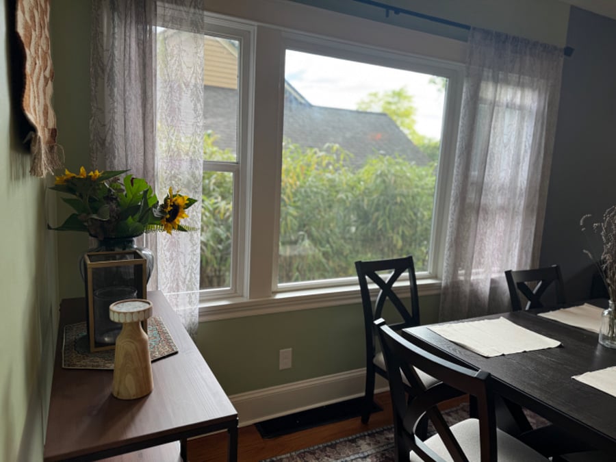 Dining room includes a large window which that offers lots of privacy with natural bamboo growing outside