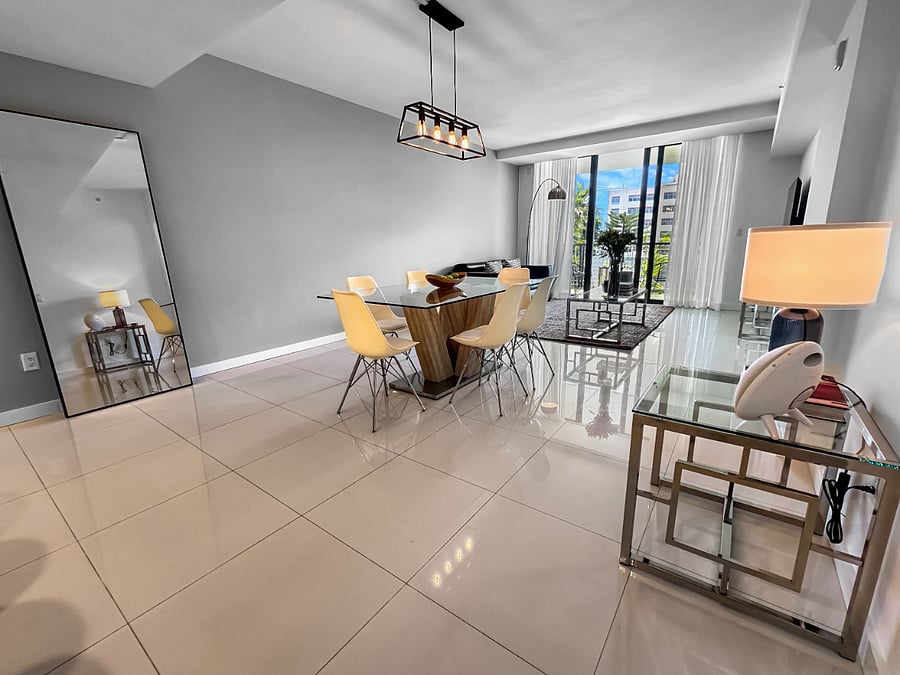 Enjoy a bright, open living room featuring a dining table and a comfortable queen sofa bedideal for relaxing, entertaining, or accommodating extra guests.