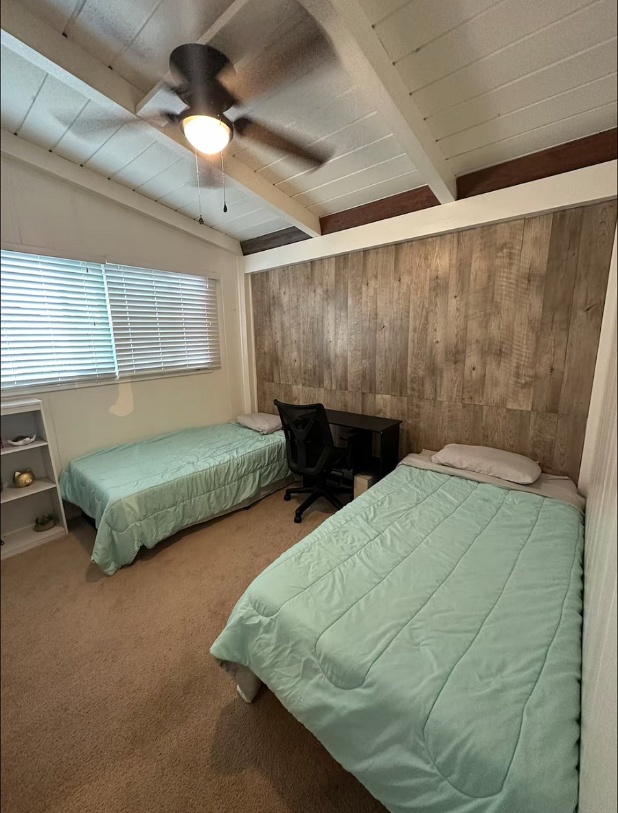 UNIT A - 2 BEDROOM

2 twin sized beds with a desk in between. Has ceiling fan in the room. 