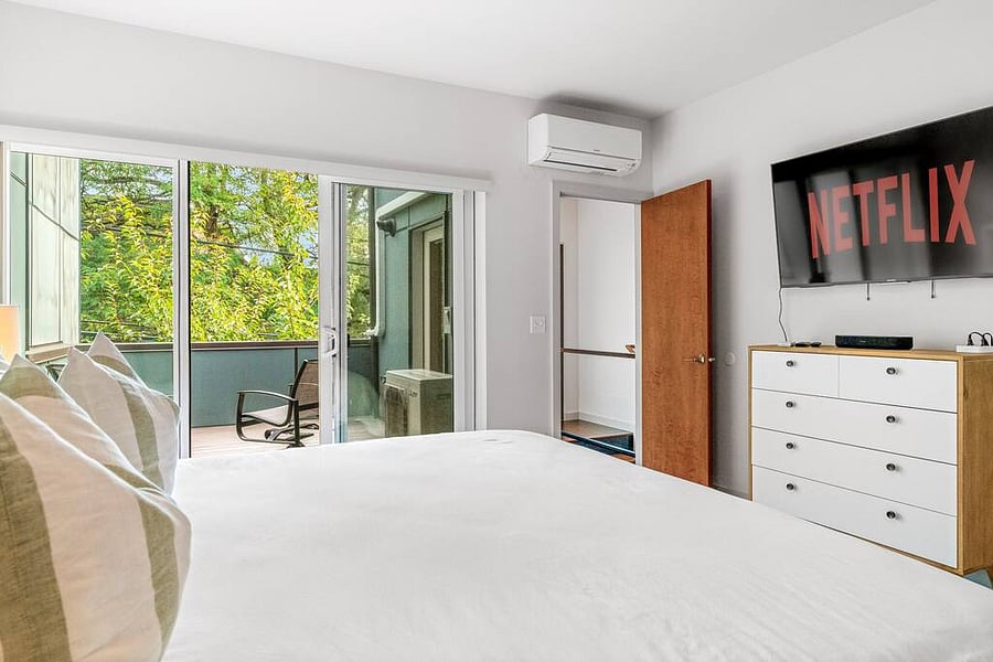 Enjoy the views and relax with a movie in this bedroom with a balcony!