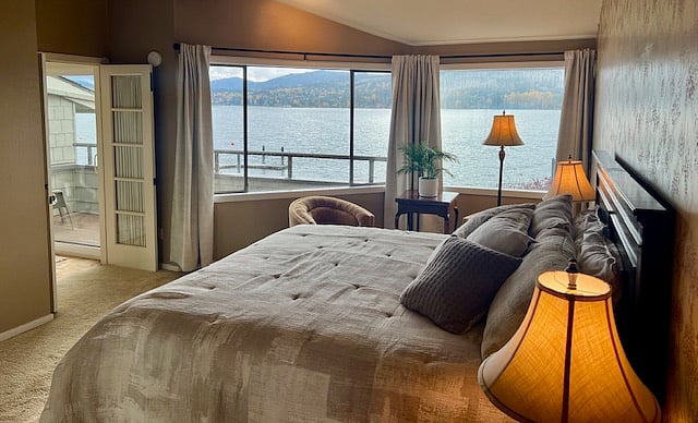 Primary bedroom with amazing views of the lake and distant hills