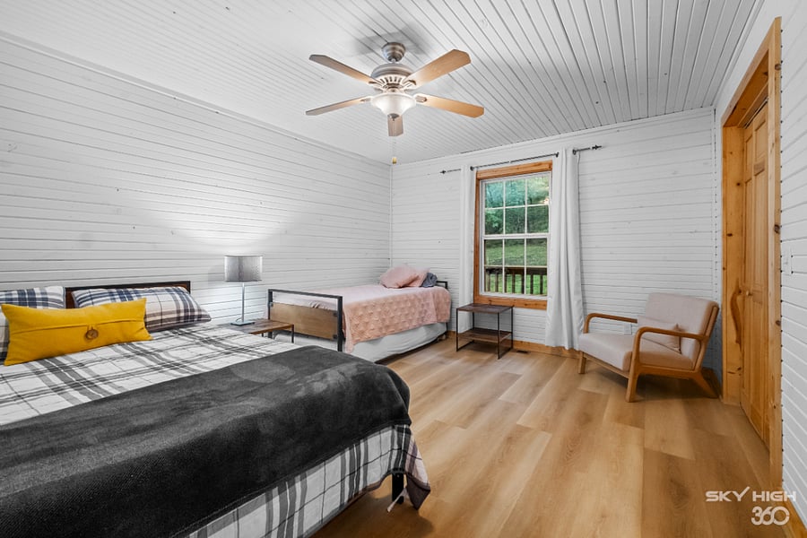 Bedroom two with queen bed and twin bed with additional trundle twin below.